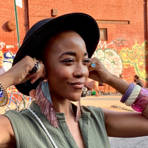 leather feathered painted earrings as worn by Sara Clark